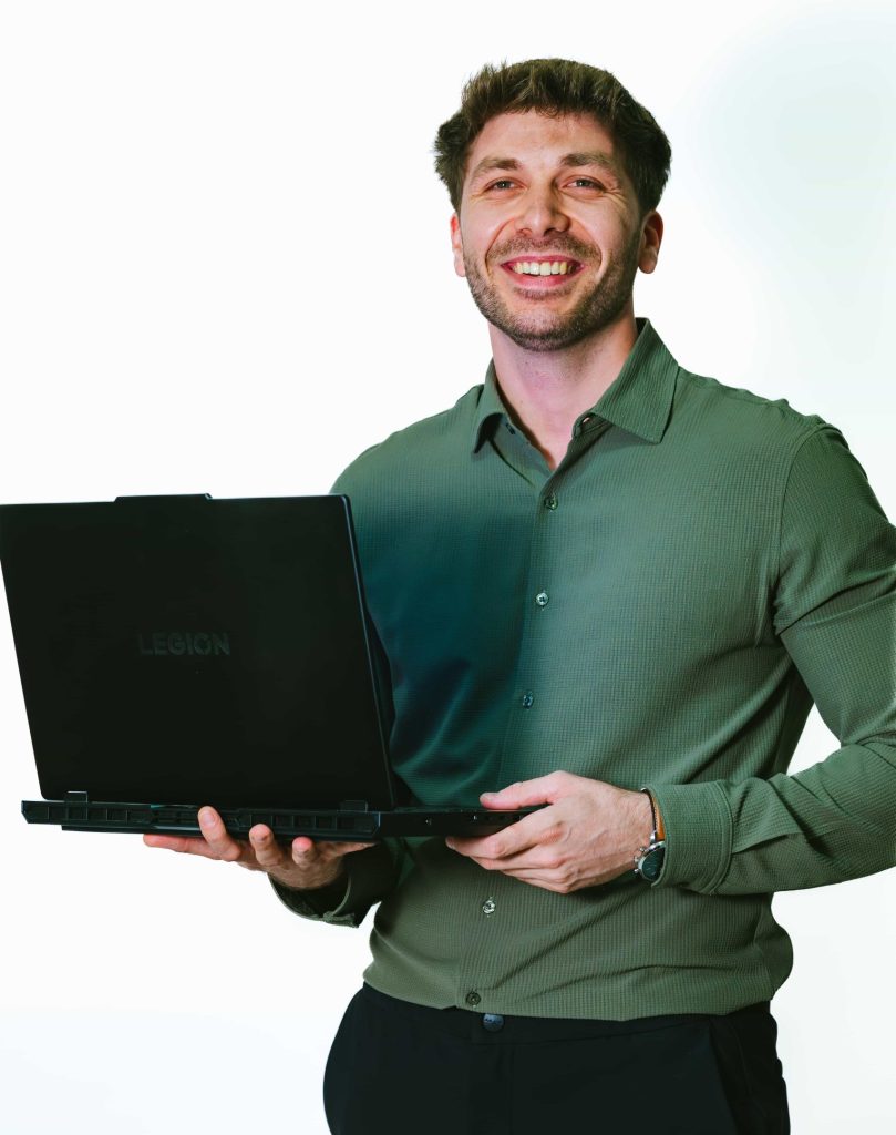 Three professionals standing and discussing documents in a modern office